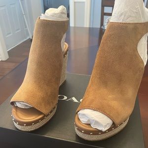 New with box. Coach suede wedges. Gold embellishments.